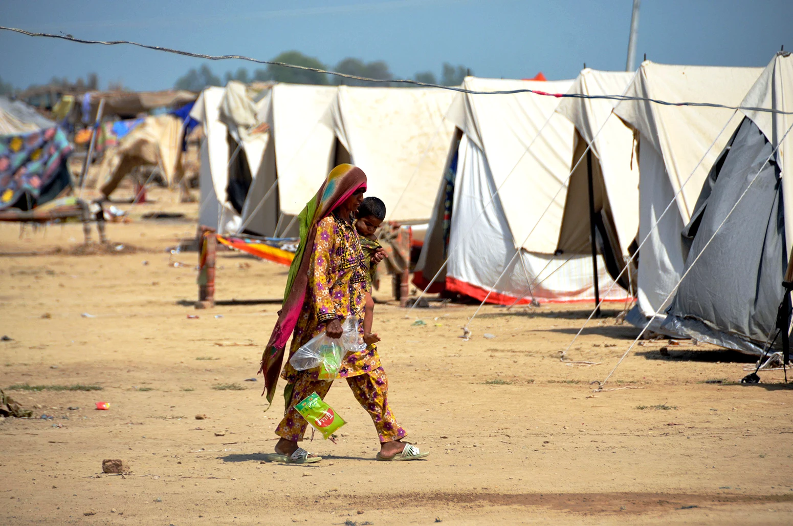 A woman takes refuge after leaving her flood-hit homes in Jaffarabad, a district of Baluchistan province, Pakistan, on 21 September 2022.